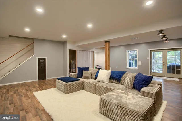 a living room with furniture and wooden floor