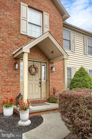 a front view of a house with a garden and plants