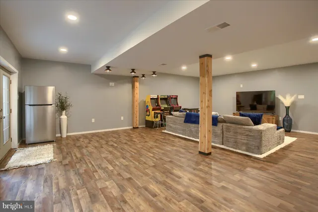 a view of a living room kitchen and a wooden floor