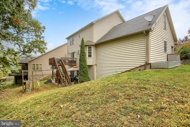 a view of a house with a yard and sitting area