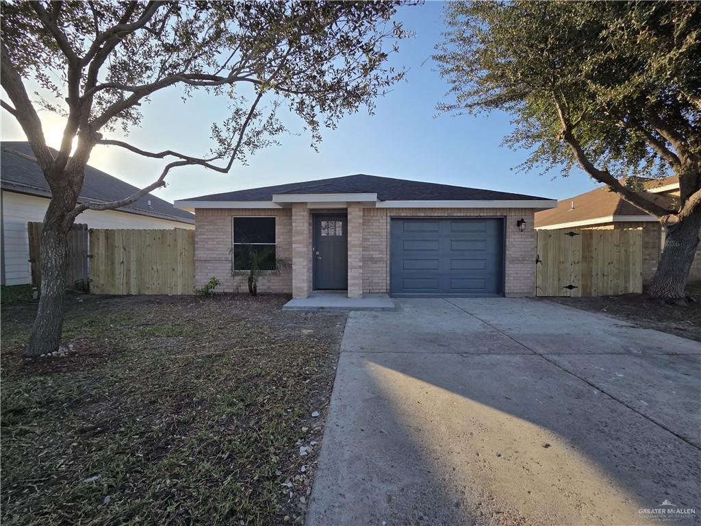 a view of a house with a yard and garage