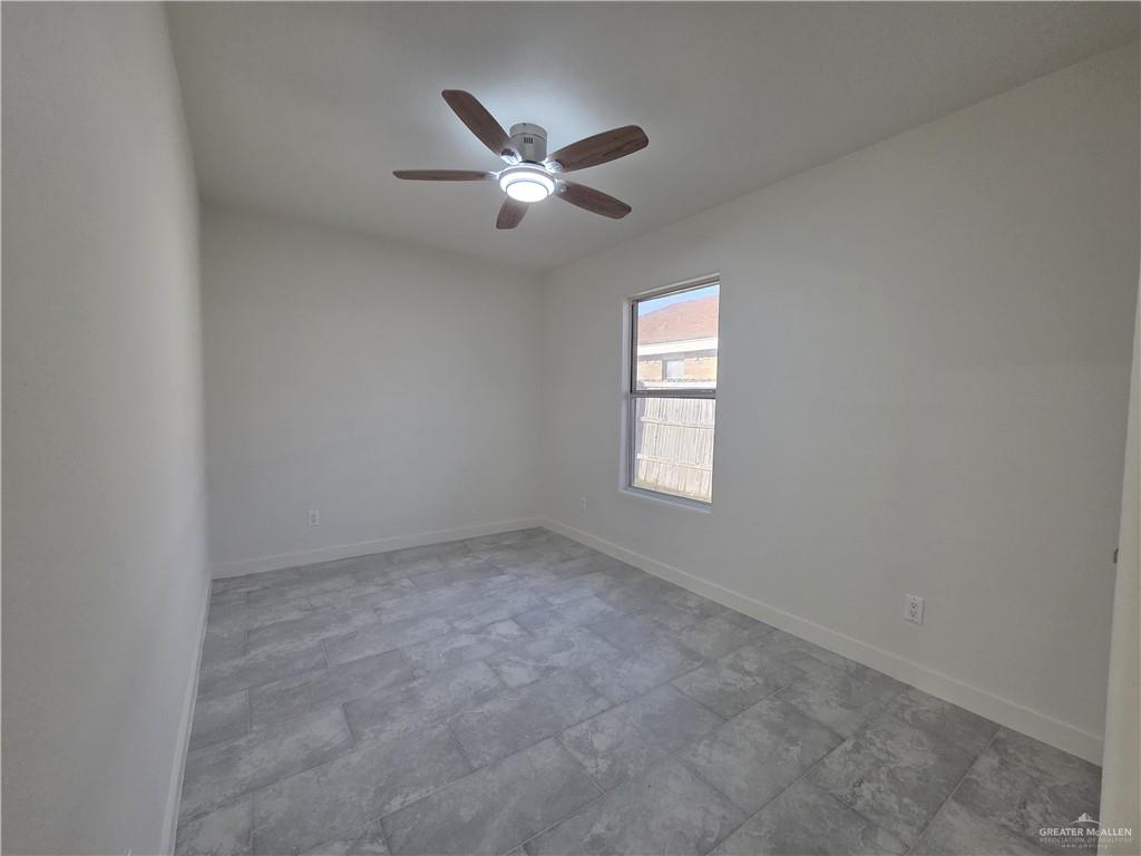 477 Serg Loop Alamo, TX 78516 - Photo 11 of 15 an empty room with windows and fan