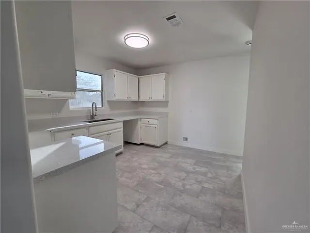 a kitchen with a sink stove and cabinets