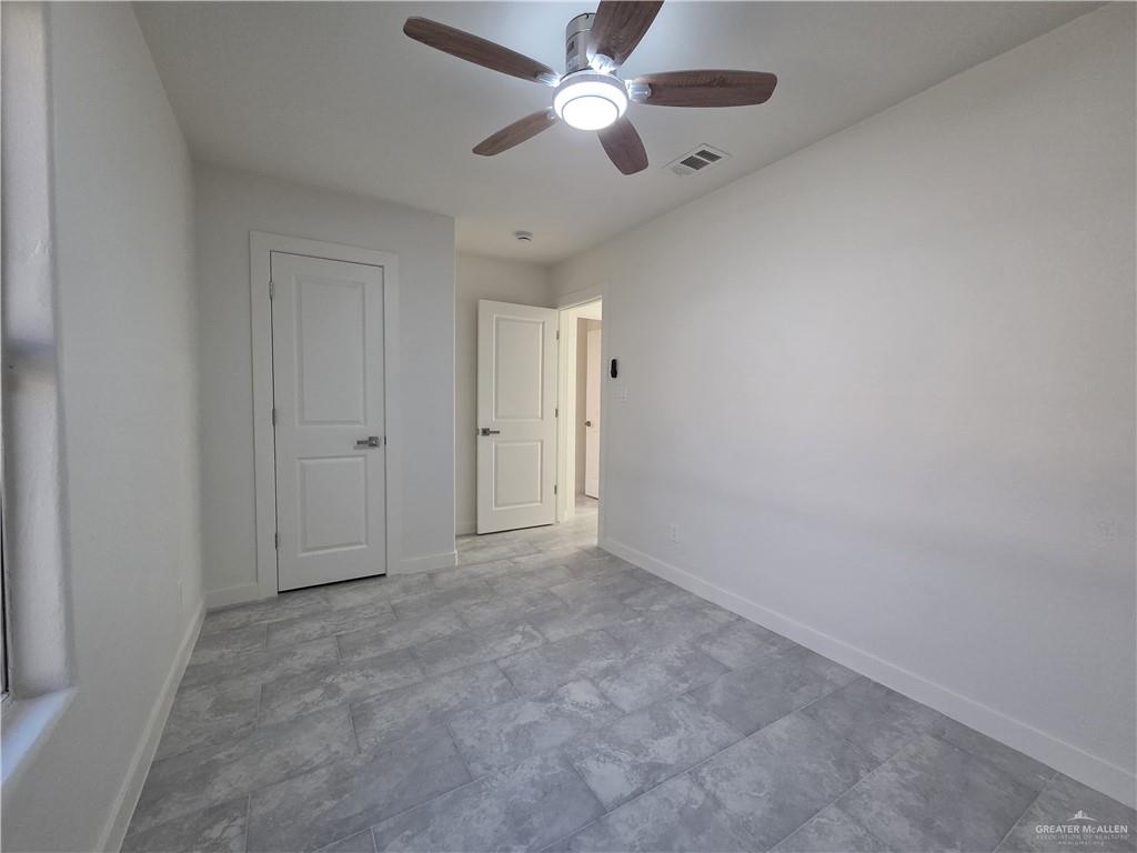477 Serg Loop Alamo, TX 78516 - Photo 7 of 15 an empty room with closet and a chandelier fan