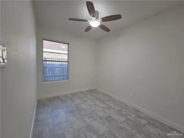 an empty room with closet and windows