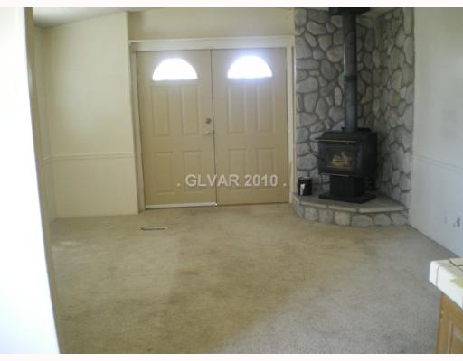 3141 Retread Road Pahrump, NV 89048 - Photo 12 of 18 Living Room. Wood burning stove Unit A living room