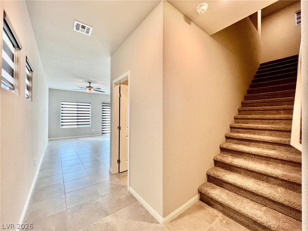 7845 Morganite Avenue Las Vegas, NV 89113 - Photo 2 of 21 A well-lit entry hall with tiled flooring extends to a versatile living space.