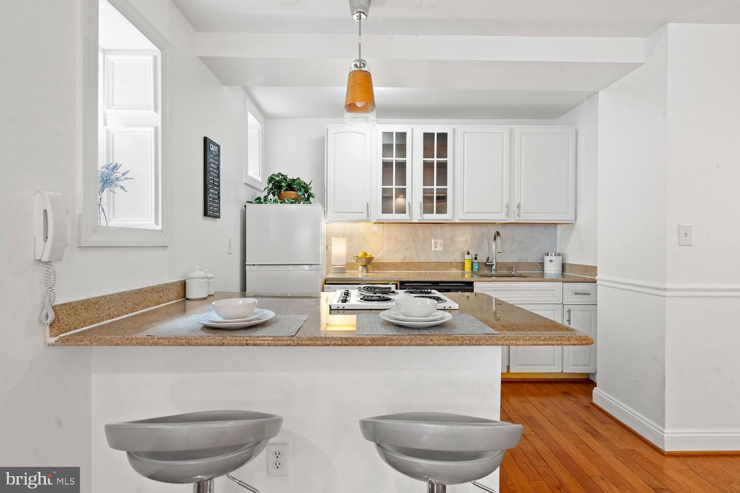 1125 12th Street Northwest, Unit 21 Washington, DC 20005 - Photo 4 of 23 a kitchen with a table and chairs