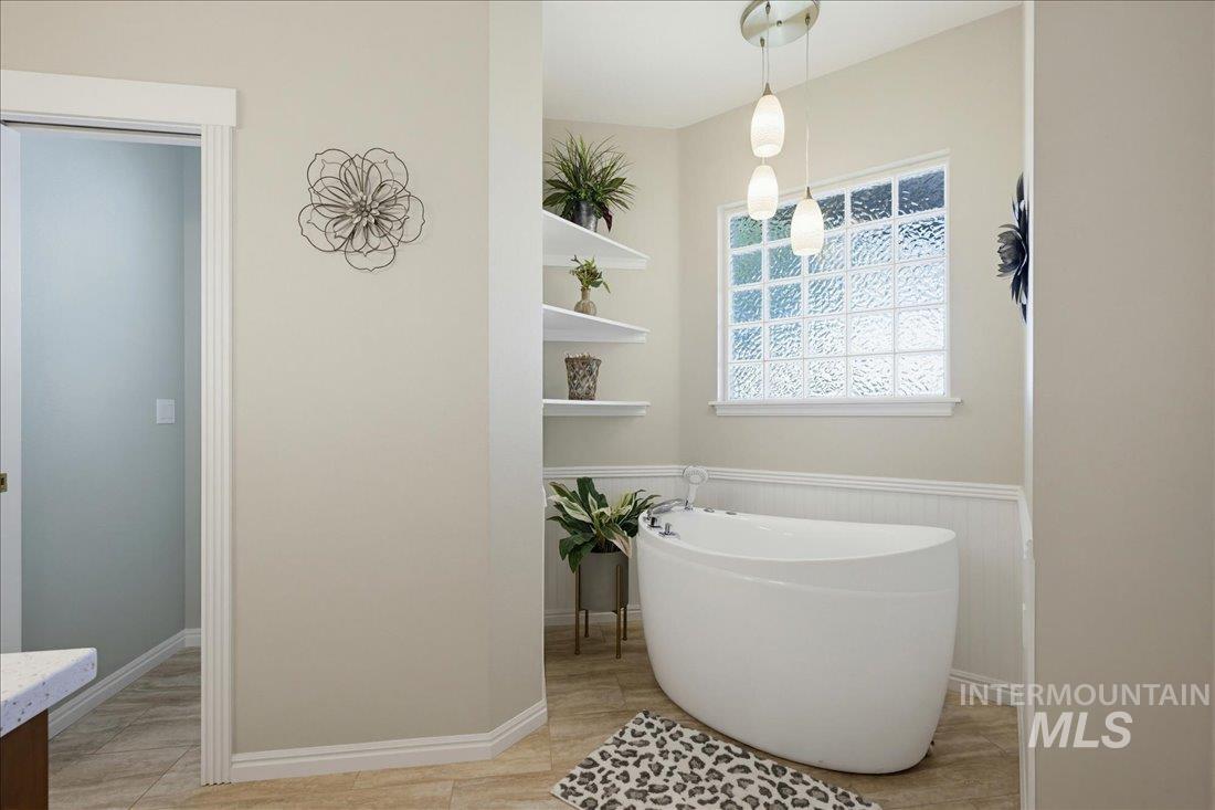 24623 Falcon Lane Caldwell, ID 83607 - Photo 19 of 40 Freestanding soaking tub centered under a glass block window