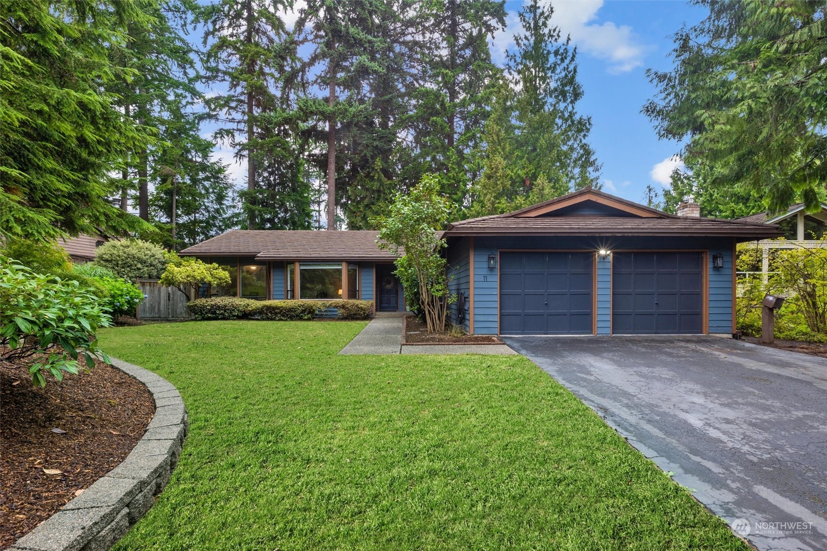 11 170th Place Southeast Bothell, WA 98012 - Photo 1 of 29 a front view of a house with a garden