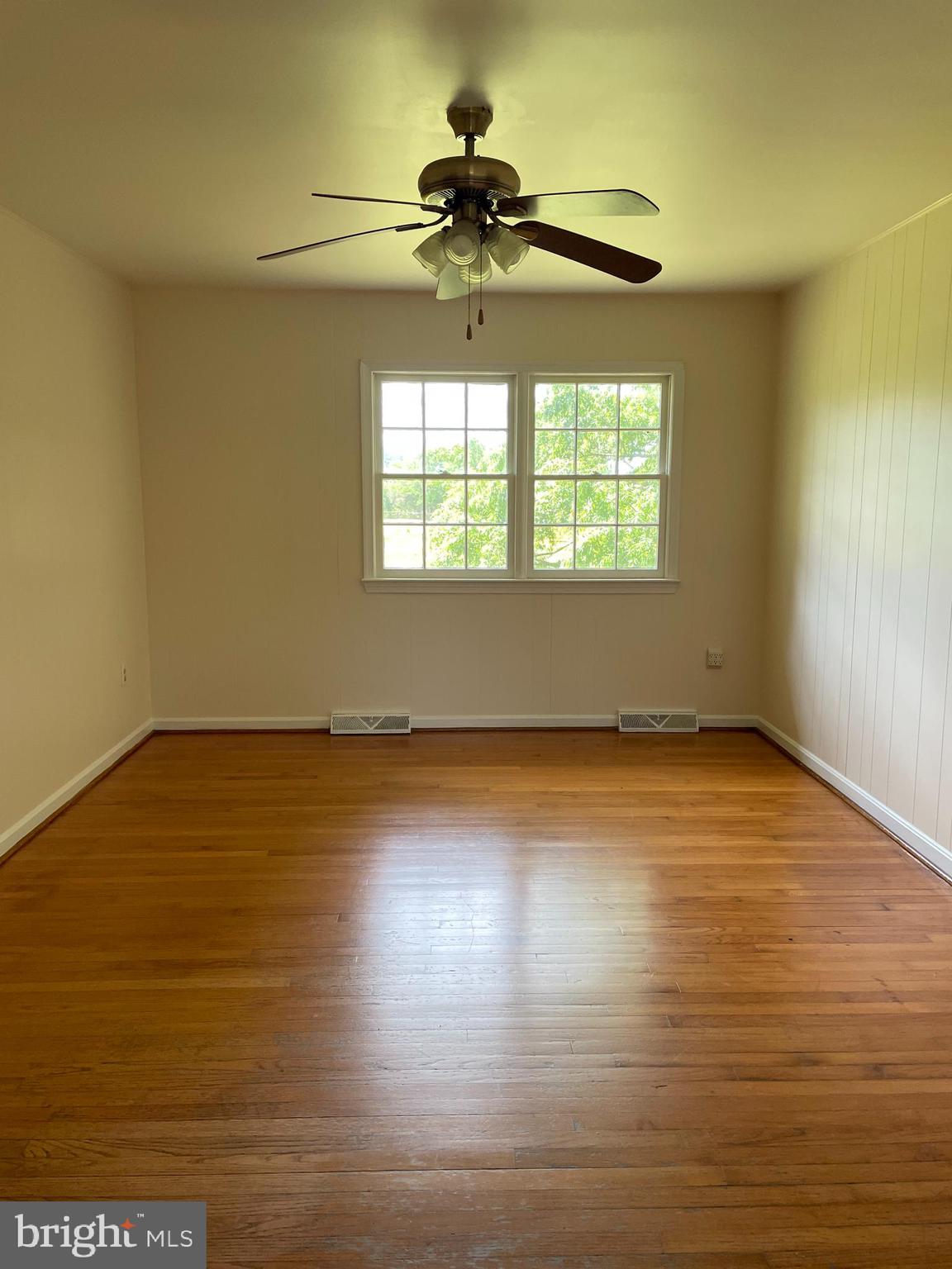 12191 Port Conway Road King George, VA 22485 - Photo 2 of 15 a view of an empty room with wooden floor and a window