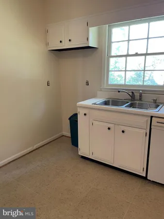 a utility room with a sink washer and dryer