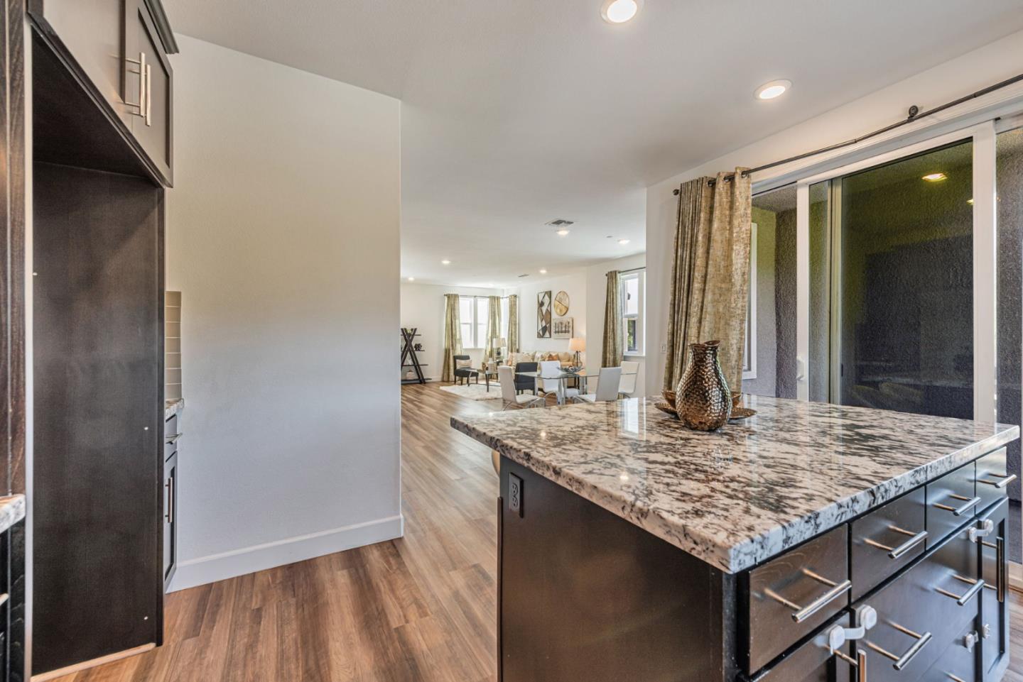 96 Zenith Common Fremont, CA 94539 - Photo 14 of 53 a kitchen with kitchen island granite countertop wooden cabinets and a counter top space