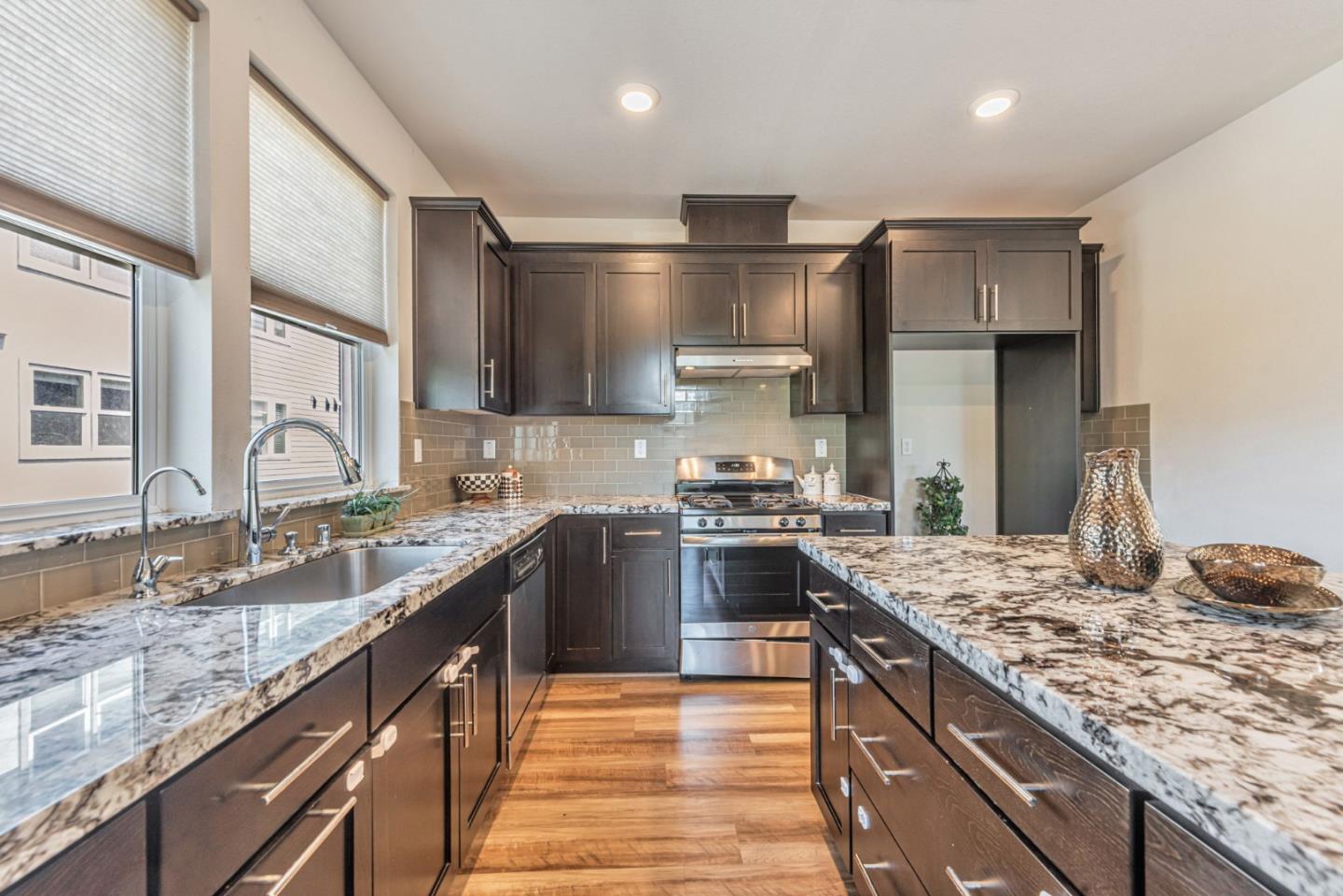 96 Zenith Common Fremont, CA 94539 - Photo 16 of 53 a large kitchen with stainless steel appliances granite countertop a sink stove and refrigerator