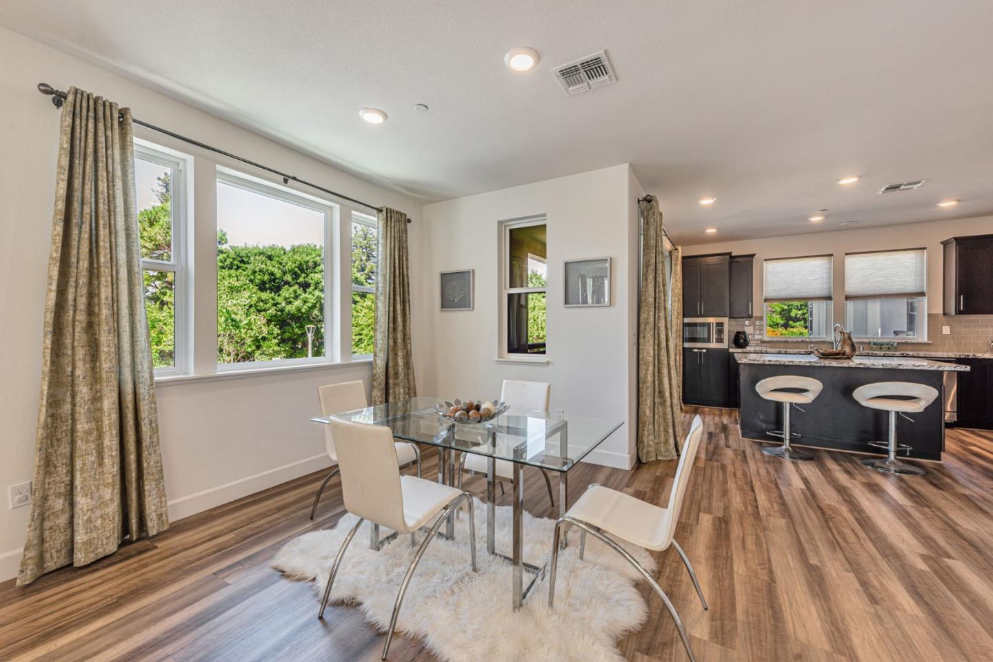 96 Zenith Common Fremont, CA 94539 - Photo 19 of 53 a view of a dining room with furniture window and wooden floor