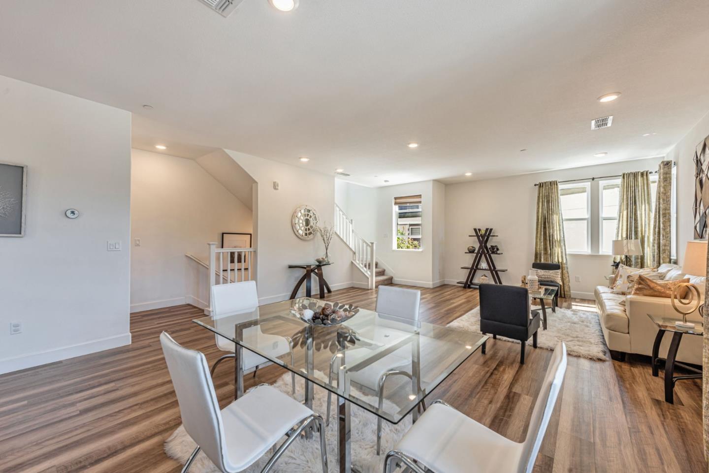 96 Zenith Common Fremont, CA 94539 - Photo 20 of 53 a living room with furniture a wooden floor and a rug