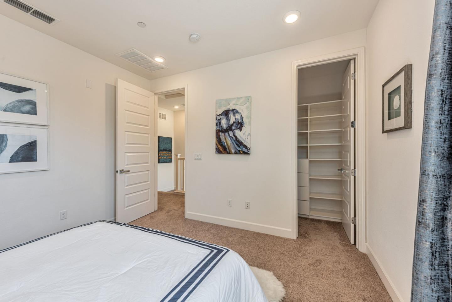 96 Zenith Common Fremont, CA 94539 - Photo 32 of 53 a bedroom with a bed and walk in closet