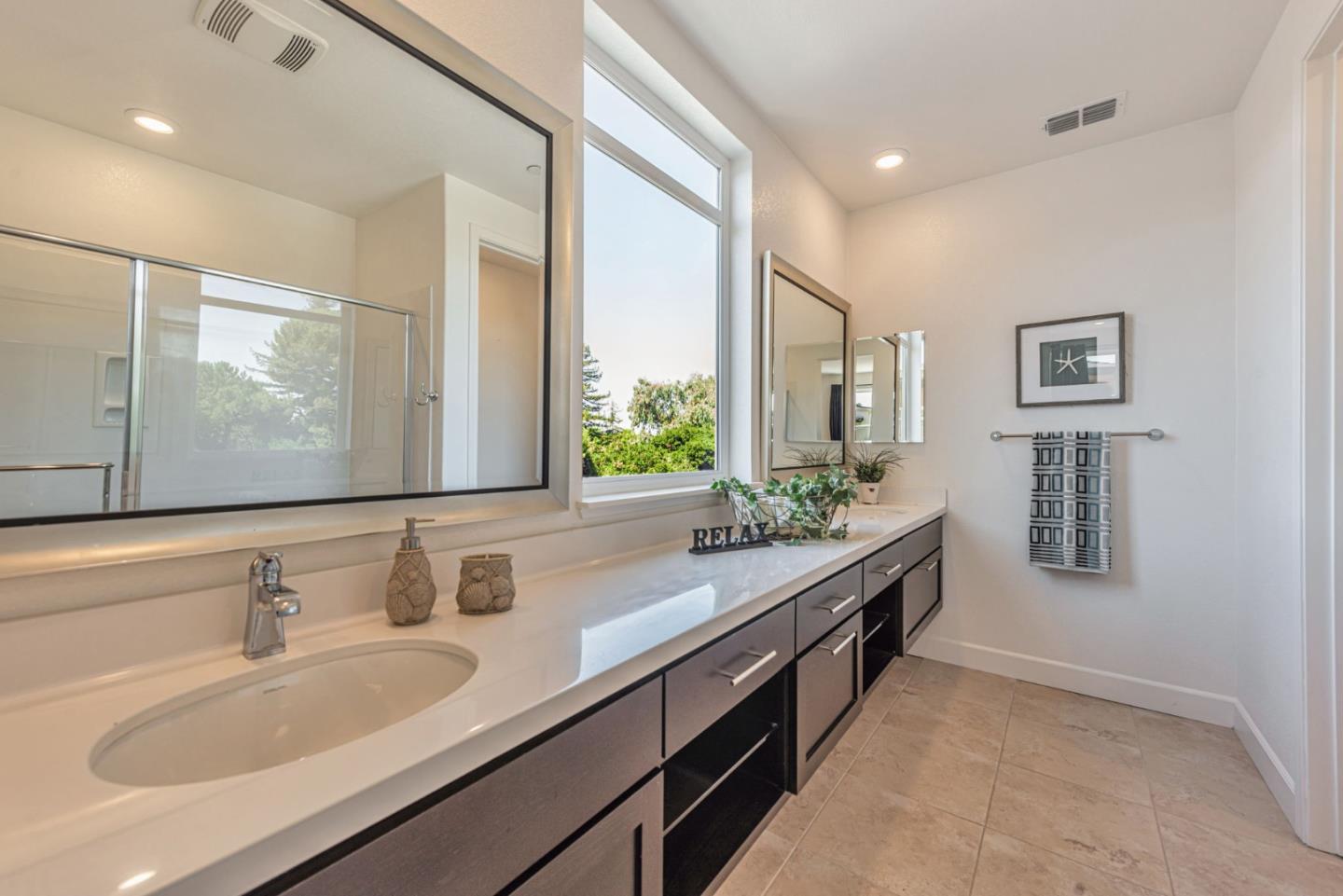96 Zenith Common Fremont, CA 94539 - Photo 33 of 53 a bathroom with double vanity sinks a large mirror and a shower