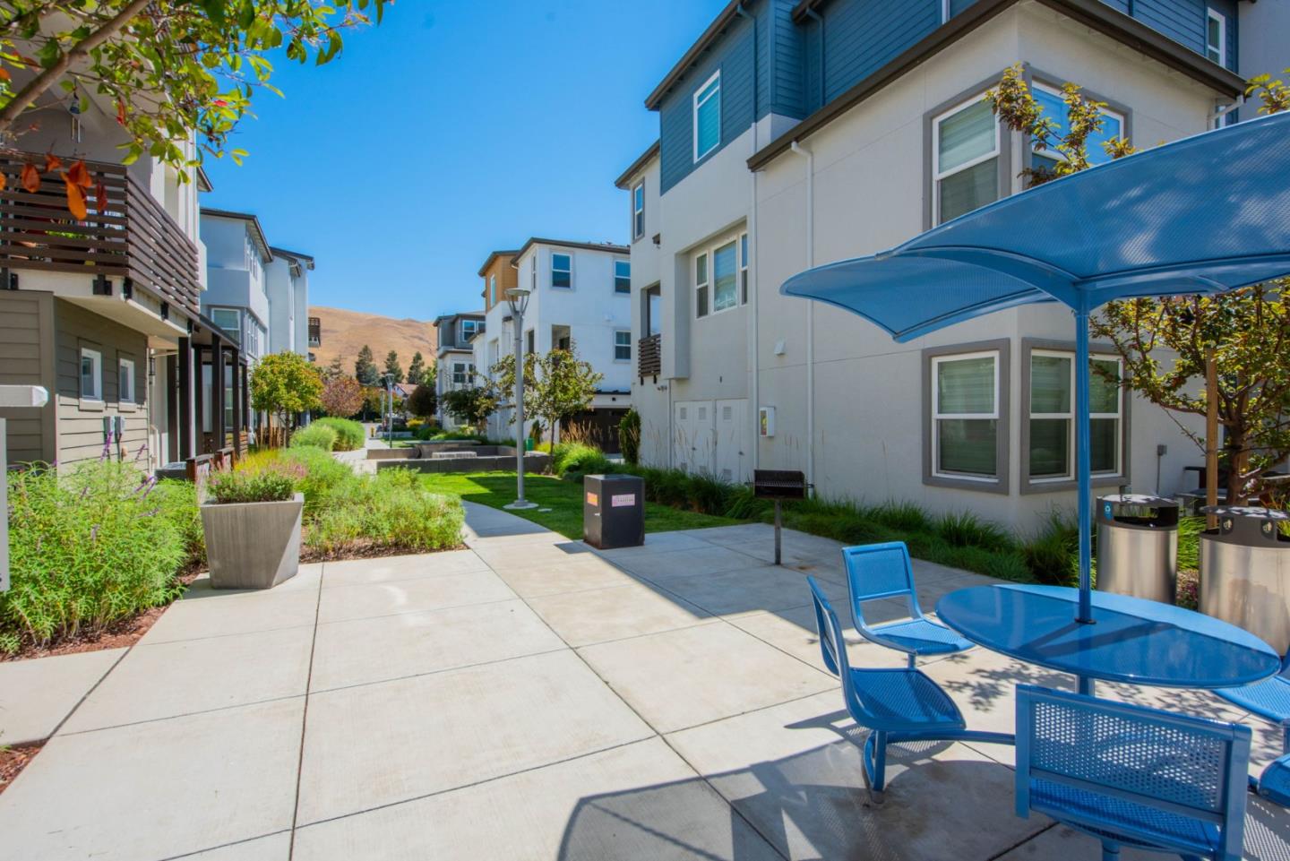 96 Zenith Common Fremont, CA 94539 - Photo 43 of 53 a view of a patio with couches table and chairs and potted plants
