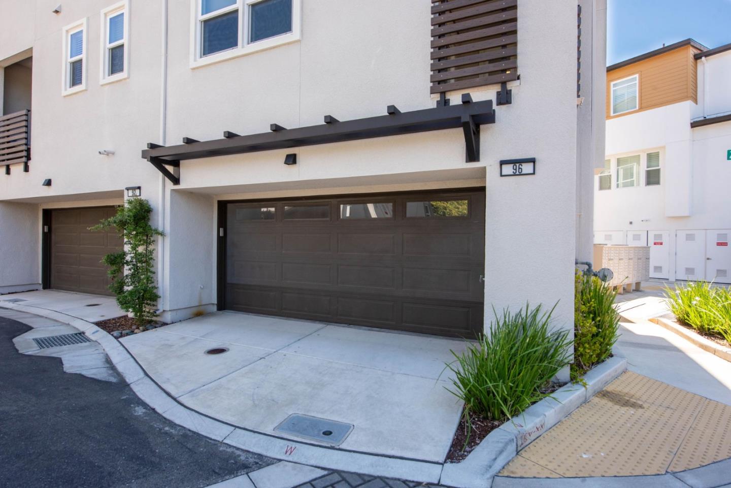 96 Zenith Common Fremont, CA 94539 - Photo 47 of 53 a front view of a house with plants