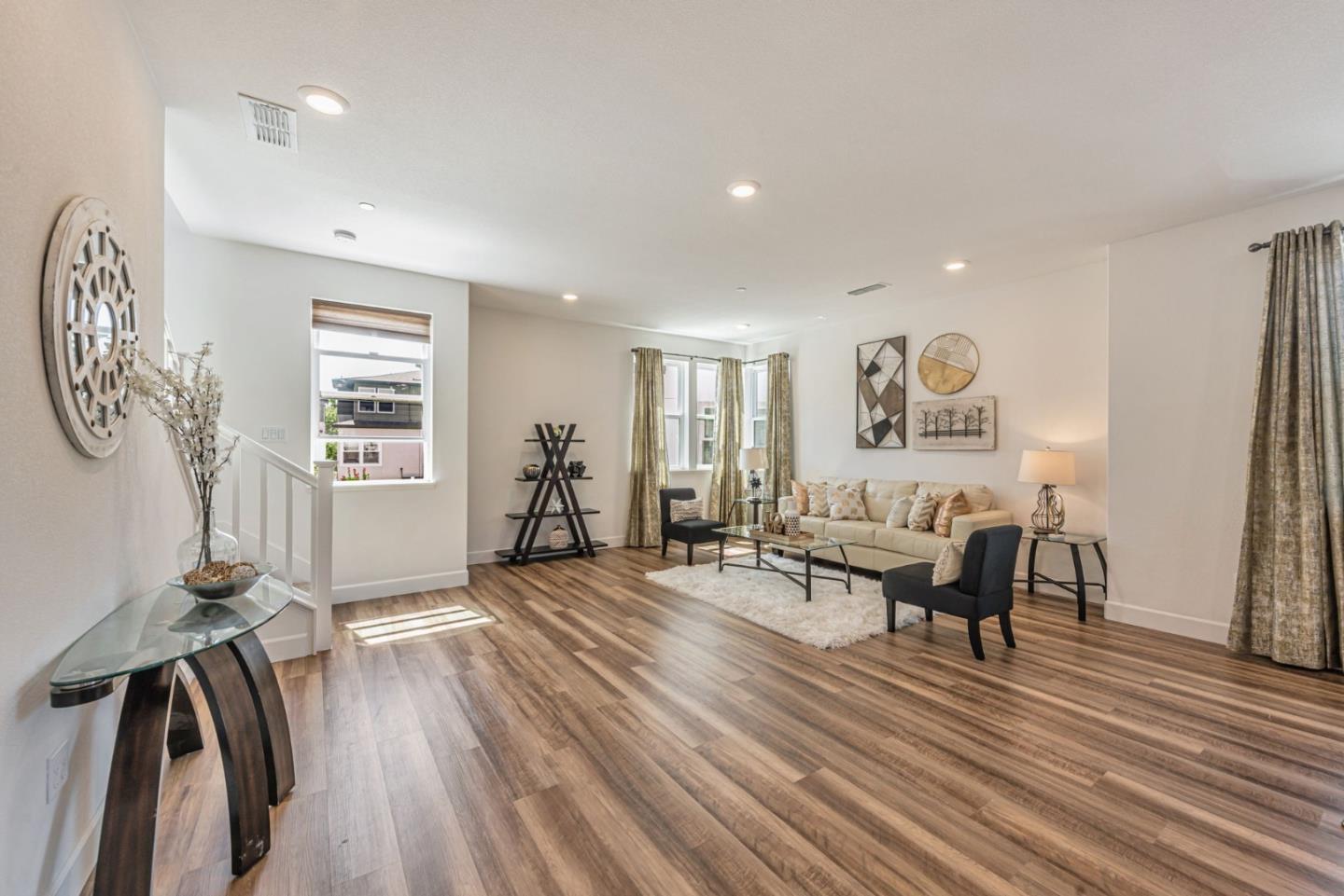 96 Zenith Common Fremont, CA 94539 - Photo 5 of 53 a living room with furniture and a wooden floor