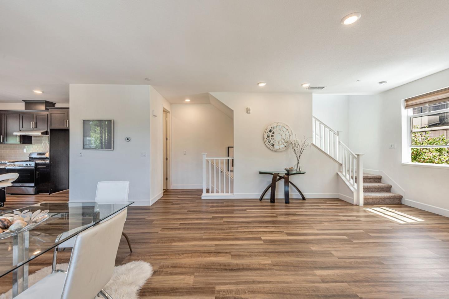 96 Zenith Common Fremont, CA 94539 - Photo 10 of 53 a room with lots of white furniture and a chandelier