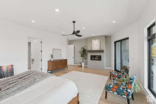 2280 East Outlaw Road, Unit 56 Kamas, UT 84036 - Photo 24 of 59 Bedroom featuring light wood-style flooring, recessed lighting, a tiled fireplace, and ceiling fan