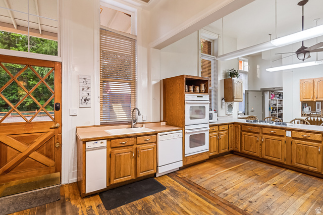 21 North Main Street Kingston, UT 84743 - Photo 64 of 107 Kitchen with dark wood-style flooring, white appliances, light countertops, wood finish cabinetry, and a high ceiling