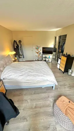 a bedroom with a bed and lamp