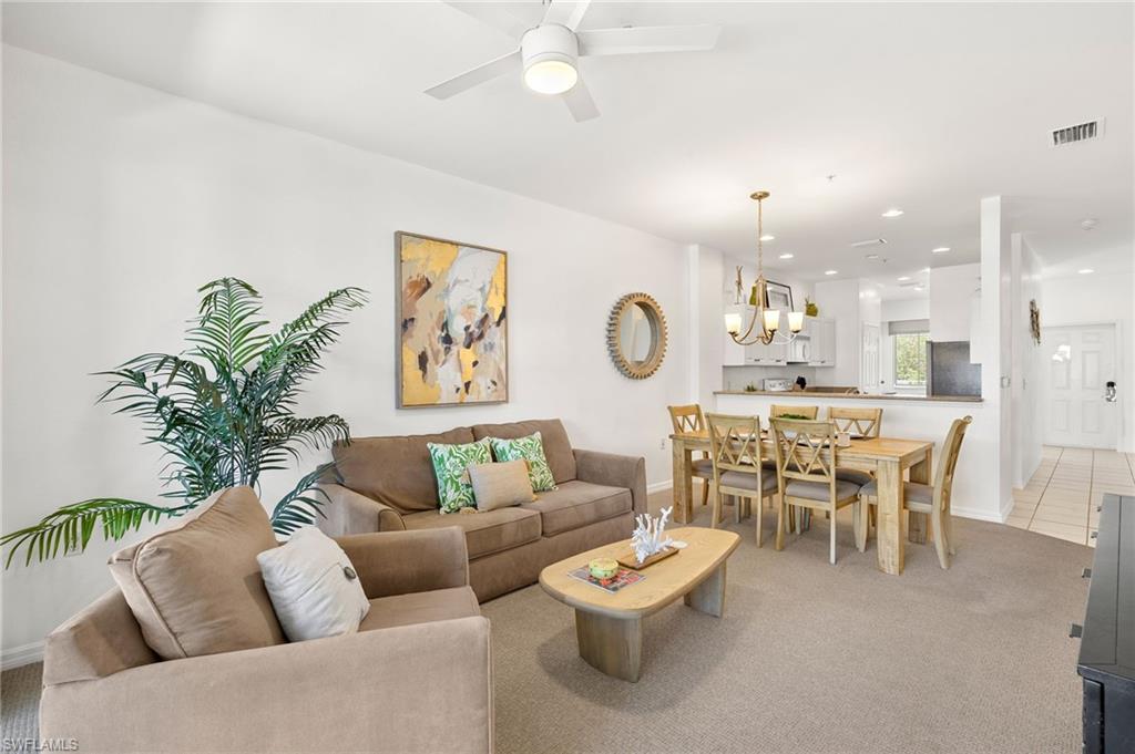 7940 Mahogany Run Lane, Unit 625 Naples, FL 34113 - Photo 16 of 30 a living room with furniture and a dining table with garden view