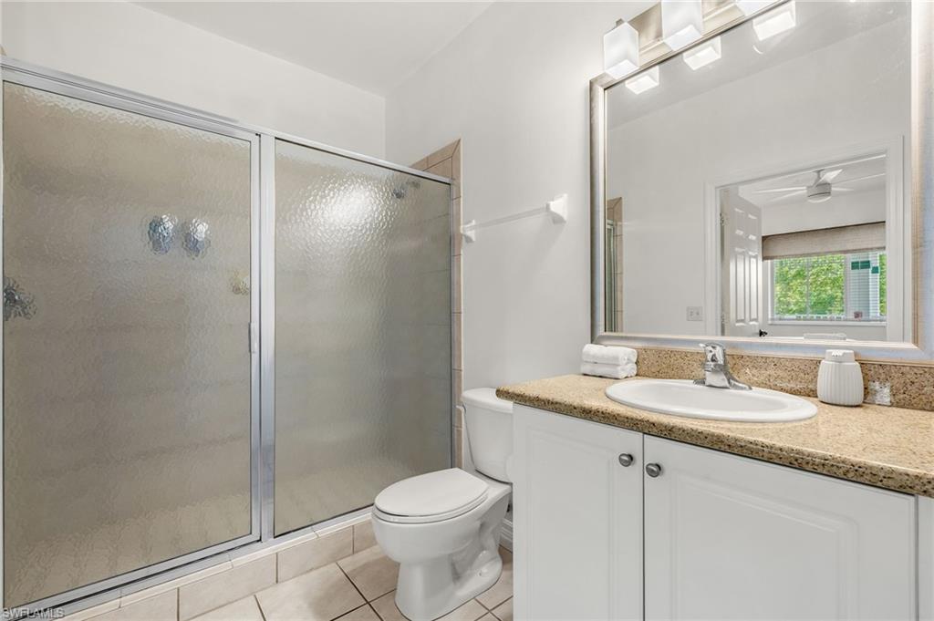 7940 Mahogany Run Lane, Unit 625 Naples, FL 34113 - Photo 20 of 30 a bathroom with a granite countertop sink toilet and shower