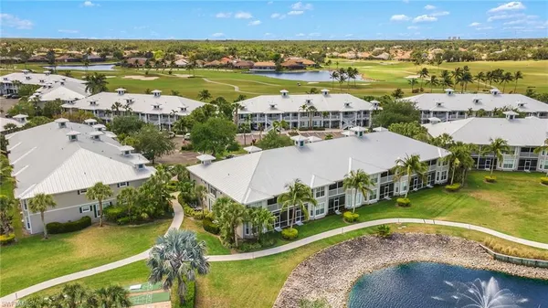an aerial view of residential houses with outdoor space and swimming pool