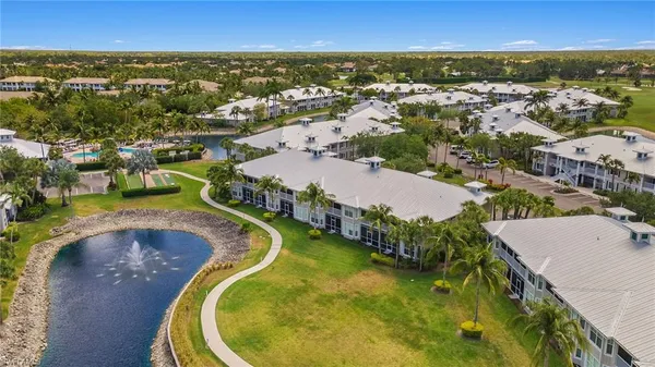 an aerial view of residential houses with outdoor space and swimming pool