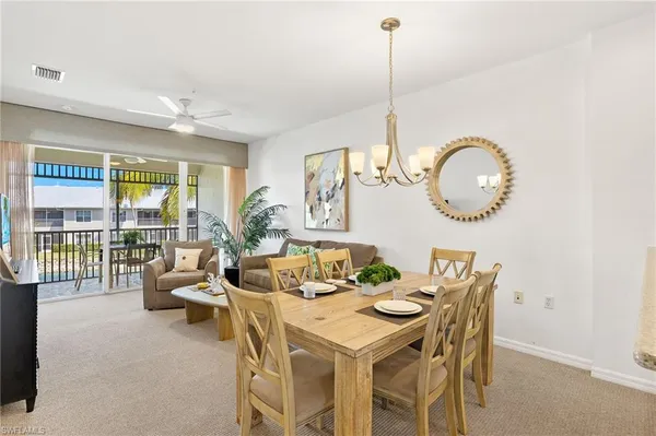 a view of a dining room with furniture wooden floor and a chandelier