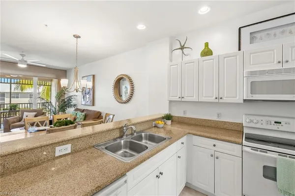 a kitchen with a sink cabinets and window