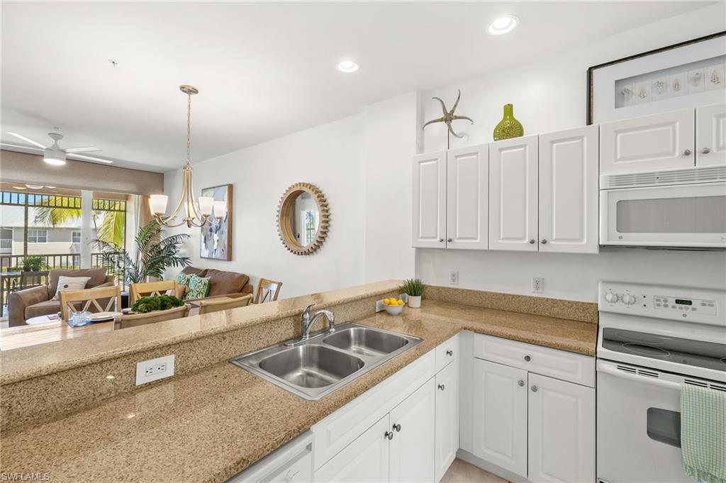 7940 Mahogany Run Lane, Unit 625 Naples, FL 34113 - Photo 5 of 30 a kitchen with a sink cabinets and window
