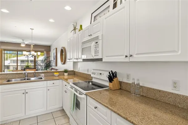 a kitchen that has a sink and cabinets