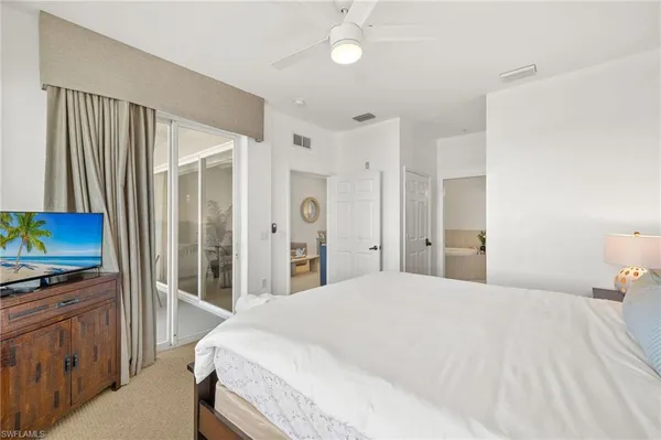 a bedroom with a bed dresser and a large mirror