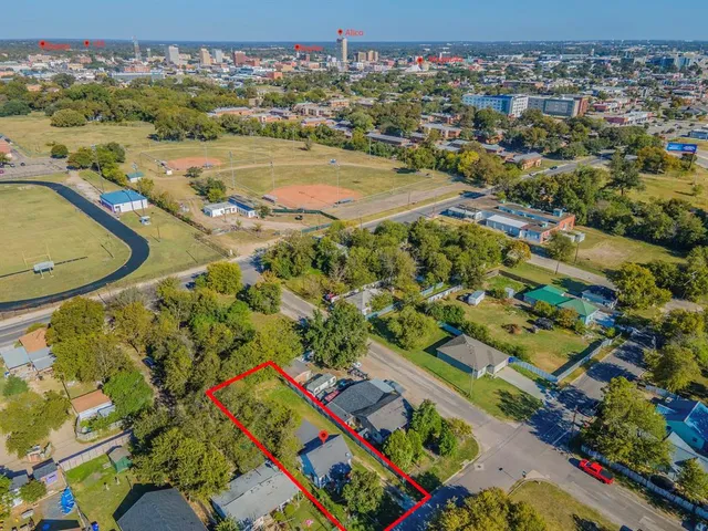 an aerial view of residential houses with outdoor space
