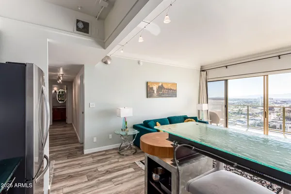 a kitchen view with wooden floor and furniture