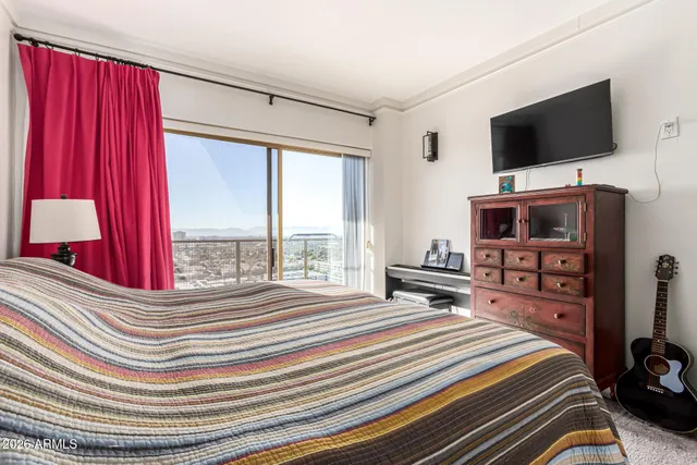 a bedroom with a bed and a flat screen tv