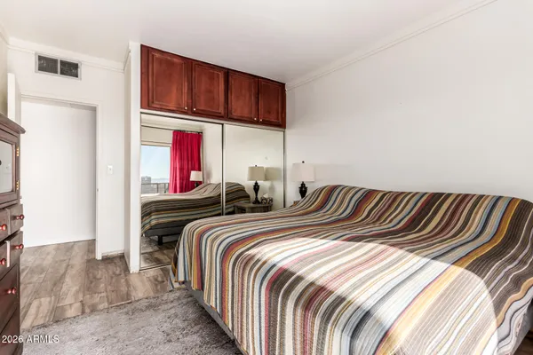 a bedroom with two beds and a closet