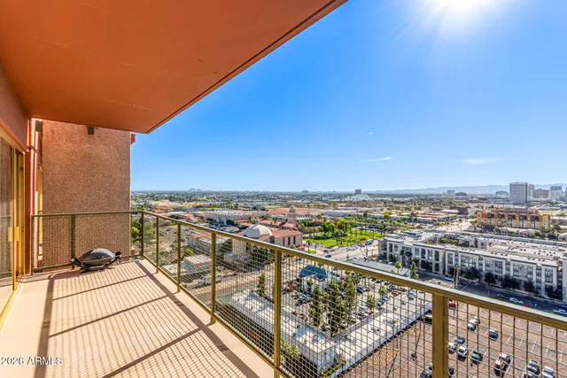 a view of a balcony with wooden floor and city view