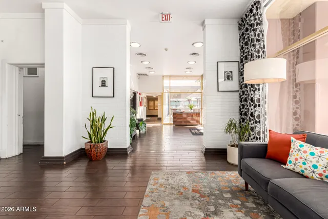 a living room with furniture and a wooden floor