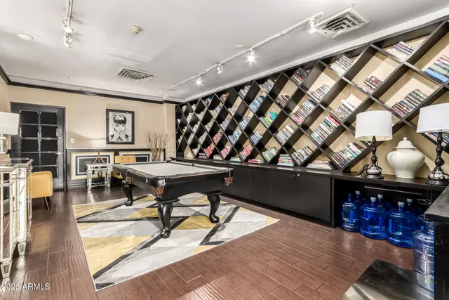 a living room with stainless steel appliances kitchen island granite countertop furniture and a rug