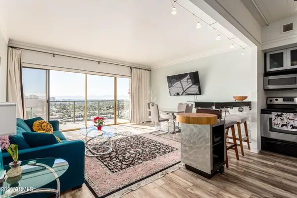 a living room with furniture and a floor to ceiling window