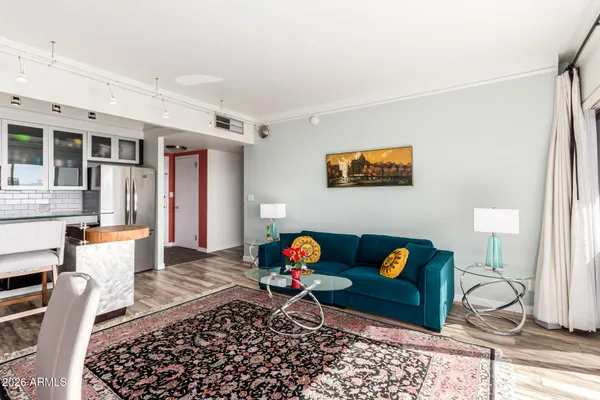 a living room with furniture and wooden floor
