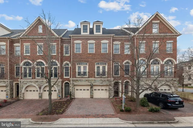 a front view of a residential apartment building with a yard