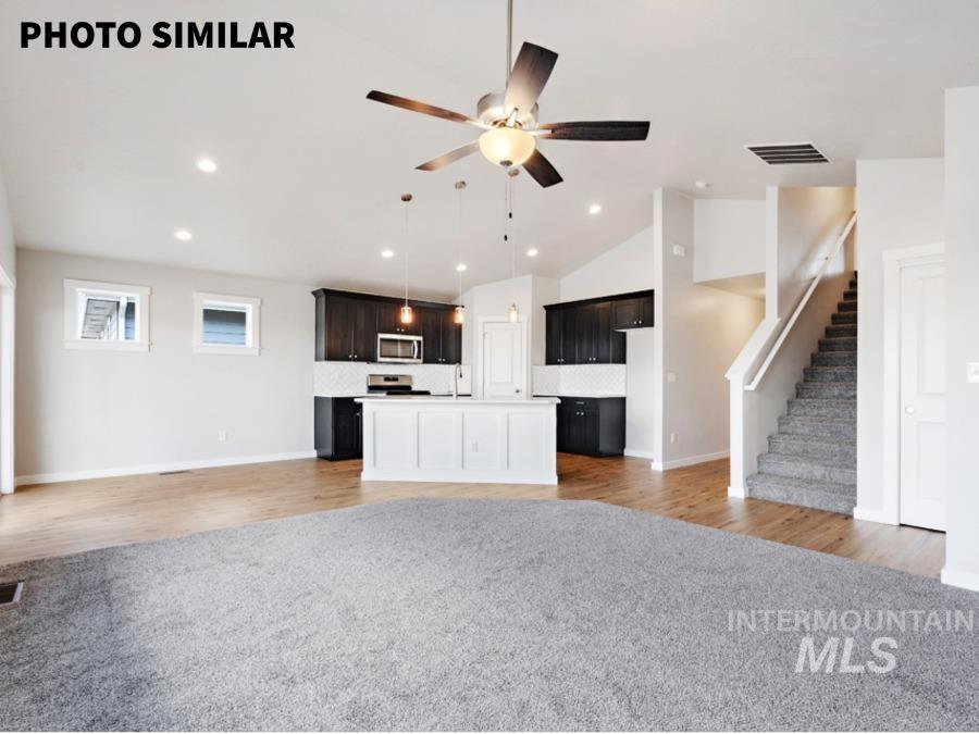 925 Twilight Weiser, ID 83672 - Photo 5 of 31 Open concept living space featuring a kitchen with dark cabinetry, stainless steel appliances, and a white subway tile backsplash