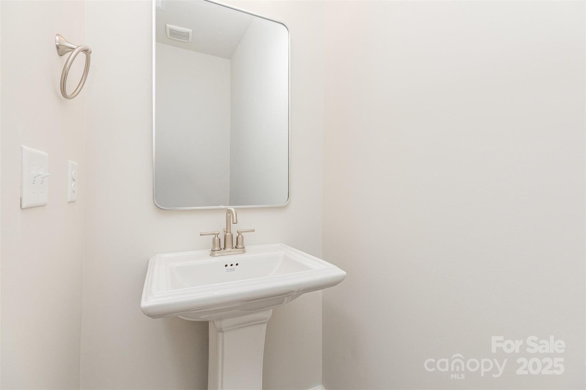 7304 Boswell Road Charlotte, NC 28215 - Photo 12 of 30 a bathroom with a sink and a mirror